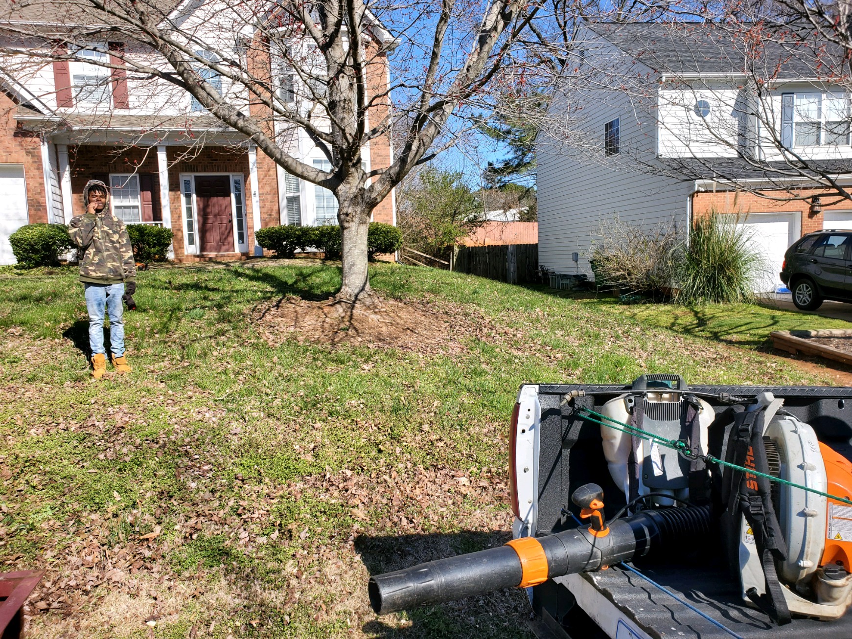 Lawn maintenance in progress with professional equipment