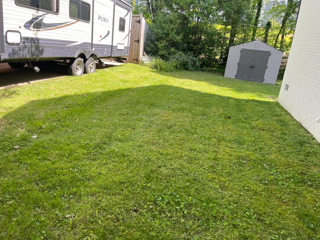 Side yard with RV parking and maintained lawn