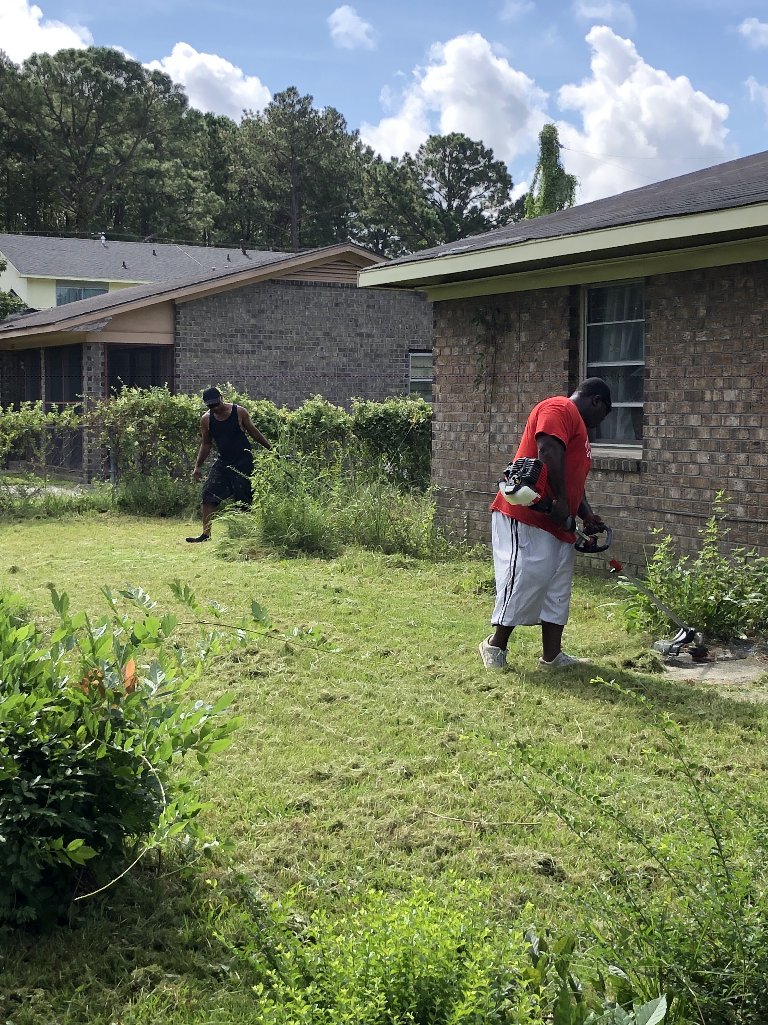 Grant's Lawn Services team working on a residential property